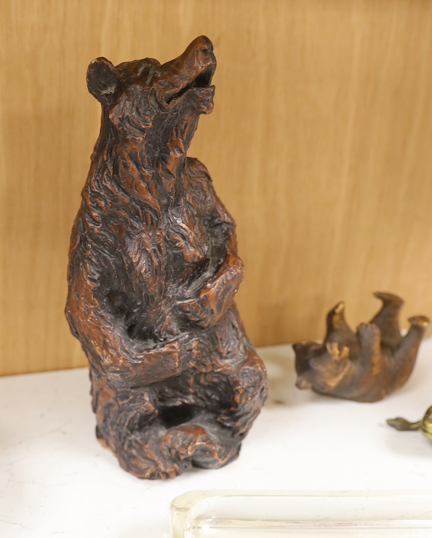 A resin Black Forest bear sculpture, a smaller Black Forest bear (possibly an ink stand but missing glass insert) together with a glass pen dish and brass hinged frog, the largest 25cm high